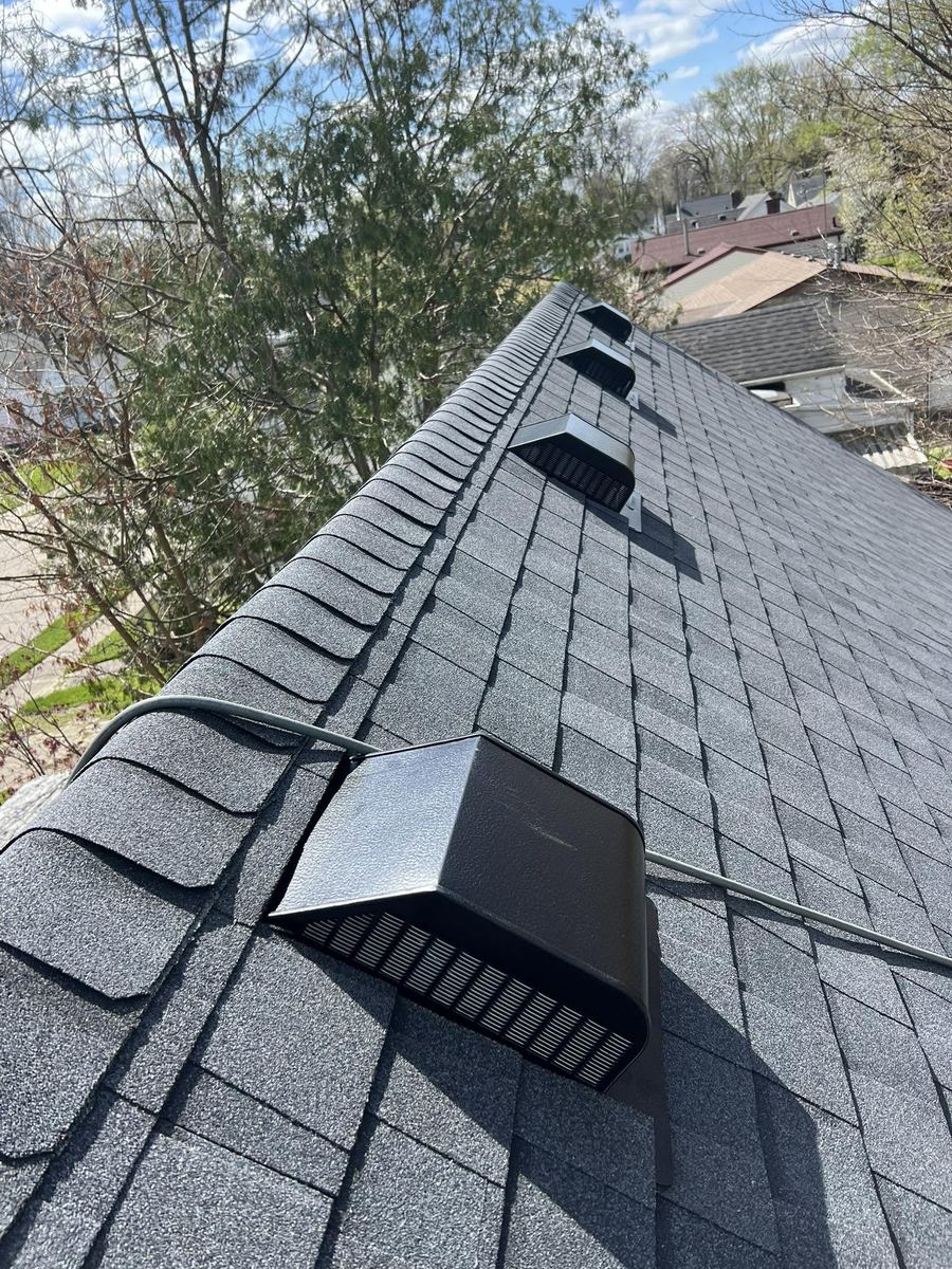 New grey shingles with roof vents installed along the ridge
